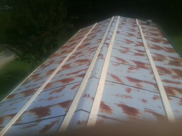 Rusted metal roof panels with new wood purlins before replacement — Storm Damage Roof Repair in Readsboro by Roofing Brothers